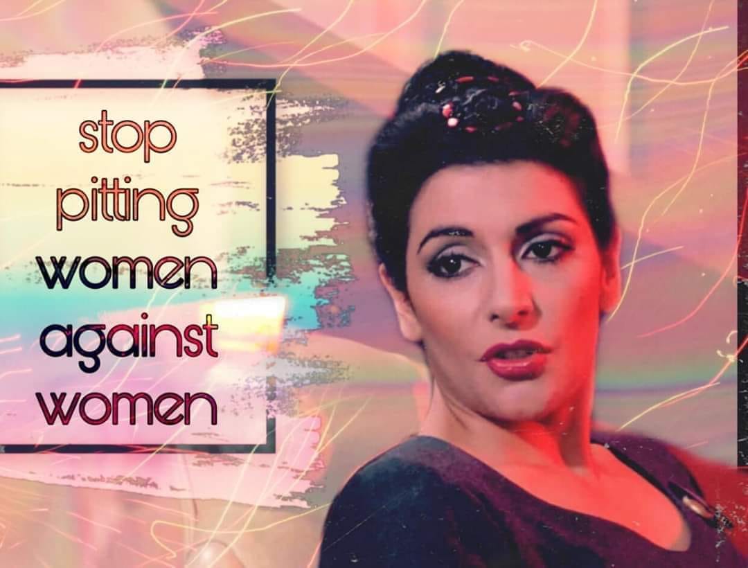 The meme features a photo of a woman with a shocked expression, likely from a TV show or movie. The text overlayed on the image reads "In 2-3 sentences, describe this meme for someone who cannot see it." This is a self-referential joke, poking fun at the idea of describing a visual image that cannot be seen.